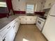 Well-lit kitchen with white cabinets, white appliances, and a practical layout at 702 Joyner St, Clayton, NC 27520