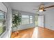 This living room has light walls, wood floors, a ceiling fan, and a window that lets in bright, natural light at 702 Joyner St, Clayton, NC 27520
