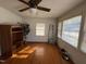 Bright living room with hardwood floors, ceiling fan, and good natural light from multiple windows at 702 Joyner St, Clayton, NC 27520