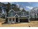 New two-story home featuring a two-car garage, gray siding, white trim, and a classic architectural design at 744 Portland Rose Dr, Knightdale, NC 27545