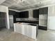 Spacious unfinished kitchen featuring dark cabinetry, an island, and ample space for customization at 744 Portland Rose Dr, Knightdale, NC 27545