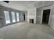 Unfinished living room area featuring french doors, a fireplace, and ample space for customization at 744 Portland Rose Dr, Knightdale, NC 27545