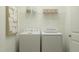 A convenient laundry room with a washer, dryer, shelving and a nearby door at 77 Sunshine Rd # 3 Mchenry, Kenly, NC 27542