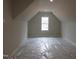 An attic featuring natural light coming through a single window at 7723 Roberts Rd, Apex, NC 27523