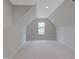 Attic space with neutral carpet, bright white walls and window at 7723 Roberts Rd, Apex, NC 27523