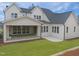 The backyard boasts a covered patio with stone fireplace and a well-manicured lawn at 7723 Roberts Rd, Apex, NC 27523