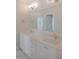 Bathroom featuring dual sinks, a large mirror, and white cabinets at 7723 Roberts Rd, Apex, NC 27523