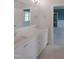 Bathroom featuring dual sinks, a large mirror, and white cabinets at 7723 Roberts Rd, Apex, NC 27523
