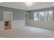 Large bedroom with neutral carpet, gray walls, and built-in desk area at 7723 Roberts Rd, Apex, NC 27523