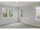 Bright bedroom featuring three windows that let in natural light at 7723 Roberts Rd, Apex, NC 27523