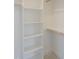 Bright closet with white shelving and wooden rods for storage at 7723 Roberts Rd, Apex, NC 27523