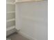 Walk-in closet with white shelving and wooden rods for hanging clothes at 7723 Roberts Rd, Apex, NC 27523