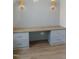 Built-in desk area with wood countertop, drawers, and panelled wall at 7723 Roberts Rd, Apex, NC 27523