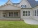Home featuring an open patio with an outdoor fireplace and well-maintained lawn at 7723 Roberts Rd, Apex, NC 27523
