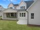 Well-maintained exterior featuring a patio with stone fireplace and spacious yard at 7723 Roberts Rd, Apex, NC 27523