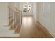 Bright foyer with hardwood floors and stairs leading up, featuring glass doors for natural light at 7723 Roberts Rd, Apex, NC 27523