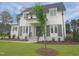 Two-story house with white brick exterior, black shutters, and a well-maintained lawn with fresh landscaping at 7723 Roberts Rd, Apex, NC 27523