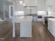 Gourmet kitchen featuring stainless steel appliances and a center island with white marble countertop at 7723 Roberts Rd, Apex, NC 27523