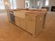 Kitchen island with farmhouse sink, stainless dishwasher, and white cabinets at 7723 Roberts Rd, Apex, NC 27523