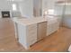 Kitchen island with marble countertop, stainless steel dishwasher and gold faucet at 7723 Roberts Rd, Apex, NC 27523