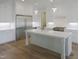 Gourmet kitchen featuring a center island, stainless steel refrigerator, and custom white cabinetry at 7723 Roberts Rd, Apex, NC 27523