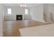 Spacious living room features fireplace, built-in cabinets, hardwood floors and stairs leading to upper level at 7723 Roberts Rd, Apex, NC 27523