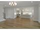 Open concept living room with hardwood floors leading into a kitchen equipped with stainless steel appliances at 7723 Roberts Rd, Apex, NC 27523
