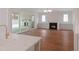 Open-concept living room with hardwood floors, fireplace, built-in cabinets, and sliding glass doors to patio at 7723 Roberts Rd, Apex, NC 27523