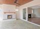 Patio with a fireplace and ample seating overlooking the landscaped yard at 7723 Roberts Rd, Apex, NC 27523