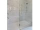 Modern shower with frameless glass door, rainfall shower head, and elegant tile work at 7723 Roberts Rd, Apex, NC 27523