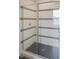 Glass enclosed shower with white and black tile at 7723 Roberts Rd, Apex, NC 27523