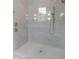 Glass enclosed shower with marble wall panels and gold water fixtures at 7723 Roberts Rd, Apex, NC 27523