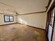 Spacious bedroom featuring a ceiling fan, natural light from a window, and wood trim at 8609 Yucca Trl, Raleigh, NC 27615