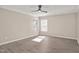 Bright bedroom featuring two windows and gray wood-look floors at 912 Obsidian Way, Durham, NC 27703