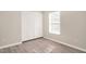 Bedroom with a window and large closet with white doors at 912 Obsidian Way, Durham, NC 27703