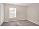 Neutral bedroom features a window and closet at 912 Obsidian Way, Durham, NC 27703