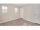 A sunlit bedroom features neutral-toned walls, updated flooring and multiple windows for ample natural light at 912 Obsidian Way, Durham, NC 27703