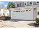 Spacious two-car garage featuring a decorative row of rectangle windows and a concrete driveway at 912 Obsidian Way, Durham, NC 27703