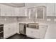 A well-lit modern kitchen features white cabinets, a stainless steel sink, and black tile flooring at 912 Obsidian Way, Durham, NC 27703