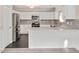Bright kitchen with white cabinets, stainless steel appliances, a tile backsplash, and an eat-in breakfast bar at 912 Obsidian Way, Durham, NC 27703
