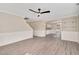 Open-concept living room with gray flooring, white wainscoting, archway, and stairs to the second floor at 912 Obsidian Way, Durham, NC 27703