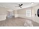 Open-concept living room with gray flooring, white wainscoting, archway, and built-in shelving at 912 Obsidian Way, Durham, NC 27703