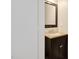 Small powder room with a dark vanity and a framed mirror at 912 Obsidian Way, Durham, NC 27703