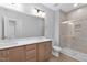 Well-lit bathroom with double sink vanity, quartz counters and a modern tiled shower with glass door at 913 Myers Point Dr, Morrisville, NC 27560