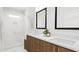Modern bathroom featuring double vanity, quartz countertops, and glass-enclosed walk-in shower with marble walls at 913 Myers Point Dr, Morrisville, NC 27560