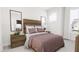 A cozy bedroom features a comfortable bed, stylish nightstands, and ample natural light from a nearby window at 913 Myers Point Dr, Morrisville, NC 27560