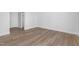 This bedroom features wood flooring, a closet, and a door that leads to another room at 913 Myers Point Dr, Morrisville, NC 27560