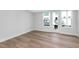 This bright bedroom features wood flooring, a window, and a glass patio door at 913 Myers Point Dr, Morrisville, NC 27560
