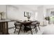 Elegant dining room featuring a wooden table with seating for six, contemporary decor, and ample natural light at 913 Myers Point Dr, Morrisville, NC 27560