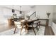 Open-concept dining area featuring a wooden table with seating, contemporary lighting, and seamless flow to the kitchen at 913 Myers Point Dr, Morrisville, NC 27560